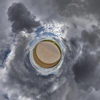 simple little tiny planet without buildings in blue sky with sun and beautiful clouds. Transformation of spherical panorama 360 degrees. Spherical abstract aerial view. Curvature of space. photo