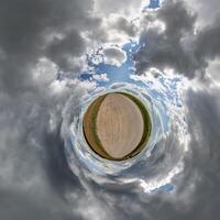 simple little tiny planet without buildings in blue sky with sun and beautiful clouds. Transformation of spherical panorama 360 degrees. Spherical abstract aerial view. Curvature of space. photo