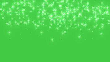 Abstract glowing particles of falling shiny fairy twinkling stars and glitter. Magic shiny sparkle rain. Chroma key - Green screen. Background for holidays, New Year and Christmas. seamless loop video