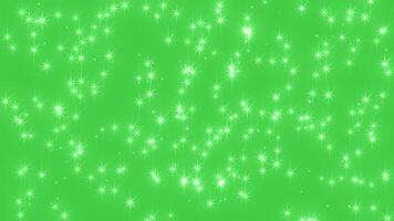 Abstract glowing particles of shiny fairy twinkling stars and glitter. The magic of flying shiny sparkle. Chroma key - Green screen. Background for holidays, New Year and Christmas. seamless loop video