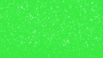 Abstract glowing particles of falling shiny fairy twinkling stars and glitter. Magic shiny sparkle rain. Chroma key - Green screen. Background for holidays, New Year and Christmas. seamless loop video