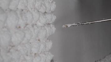 Close-up wall decoration using white foam mounting, creating a three-dimensional bas-relief with mounting foam and gun. video