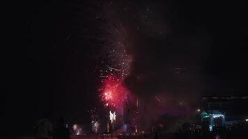 New Year Eve Fireworks Display on Bali Beaches and Silhouette of People Celebrating it in Slow Motion video