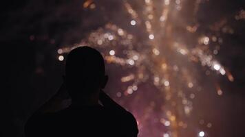 New Year Eve Fireworks Display on Bali Beaches and Silhouette of People Celebrating it in Slow Motion video
