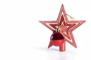 A red star shaped ornament with a red ball on top photo
