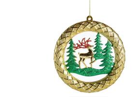 A gold ornament with a deer and pine trees photo