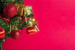 Christmas tree with ornaments on red background photo