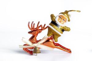 A christmas ornament with a santa claus riding a reindeer photo