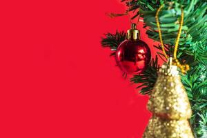 Christmas tree with ornaments on red background photo
