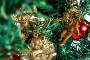 Christmas tree ornament with gold angel and red ball photo