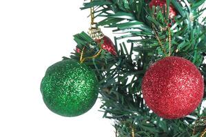 A green and red christmas ornament on a tree photo