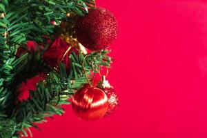 Christmas tree with ornaments on red background photo