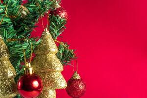 Christmas tree with ornaments on red background photo