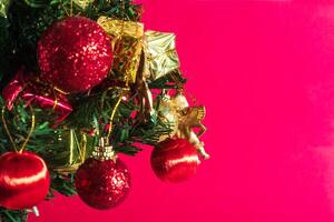 Christmas tree with ornaments on pink background photo