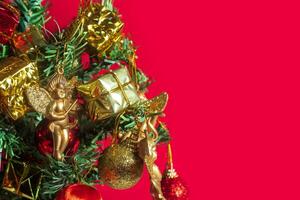 Christmas tree with ornaments on red background photo