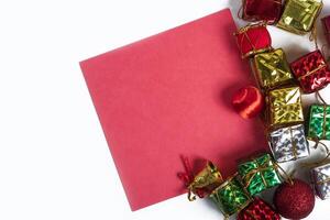 A red paper with christmas decorations on top of it photo
