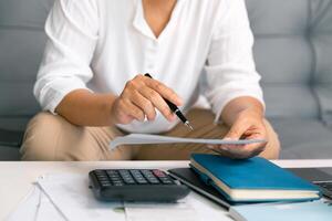 After inspecting finance documents and paperwork, he carefully calculated each tax deduction before filing, hoping for substantial refund on his income. interest, manager, pay, plan, preparation, irs photo