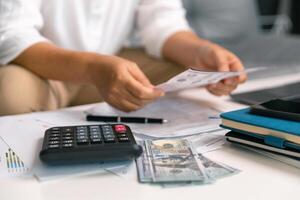 After inspecting finance documents and paperwork, he carefully calculated each tax deduction before filing, hoping for substantial refund on his income. interest, manager, pay, plan, preparation, irs photo