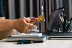 Woman sat at home using her computer to buy items online, seamlessly making purchases through various e-business platforms with her credit card, enjoying convenience of digital shopping. sell, money photo