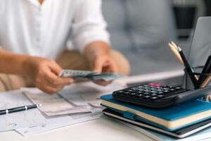 After inspecting finance documents and paperwork, he carefully calculated each tax deduction before filing, hoping for substantial refund on his income. interest, manager, pay, plan, preparation, irs photo