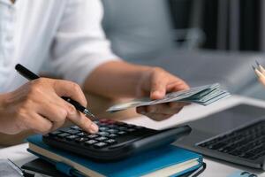 After inspecting finance documents and paperwork, he carefully calculated each tax deduction before filing, hoping for substantial refund on his income. interest, manager, pay, plan, preparation, irs photo