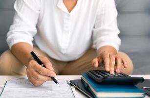 After inspecting finance documents and paperwork, he carefully calculated each tax deduction before filing, hoping for substantial refund on his income. interest, manager, pay, plan, preparation, irs photo
