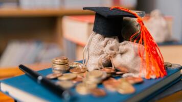 Planning for education abroad involves saving money and making wise investments in finance, which can lead to graduation success, future wealth, cognitive growth, and well-managed budget. hat, idea photo
