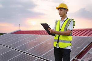 man in a yellow vest is standing on a roof and looking at a clipboard photo