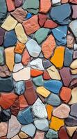 Colorful smooth pebbles tightly packed, creating a vibrant mosaic pattern. Multicolored background. photo