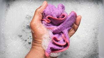 Hands squeeze wet towel , draining water from wet towel.. video