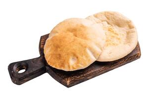 A stack of pita breads isolated on white background. top view photo