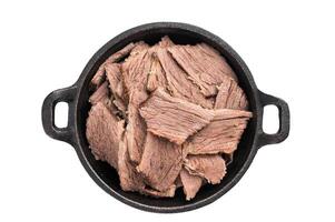 Boiled and sliced beef meat with spices and herbs isolated on white background photo