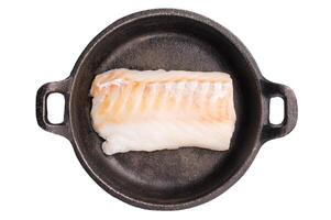 Raw cod fish fillets, whitefish without skin in skillet isolated on white background photo