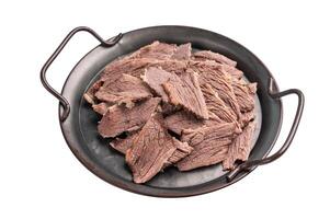 Boiled and sliced beef meat with spices and herbs isolated on white background photo