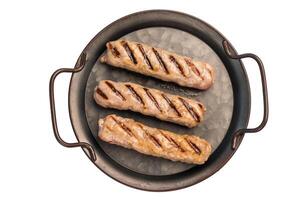 Grilled sausages with beef and pork meat isolated on white background photo