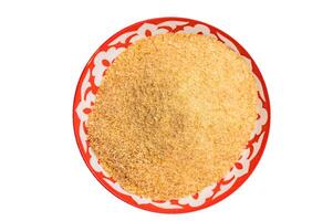 Bread Crumbs or Crushed Rusk Crumbs in a plate isolated on white background. top view photo