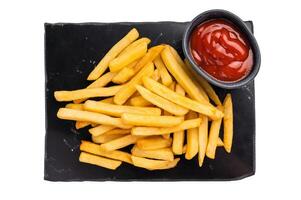French fries, chips with sauce on a kitchen board isolated on white background photo
