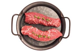 Raw Tri Tip Steak from Black Angus beef meat in stell tray isolated on white background photo