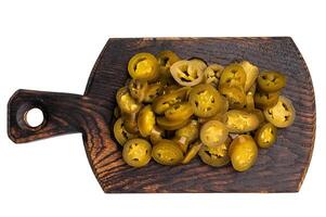 Pickled Marinated sliced Jalapeno, Green Mexican pepper on a wooden board isolated on white background photo