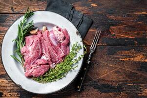 Pieces of raw turkey thigh, Poultry fresh meat. Wooden background. Top view. Space for text photo