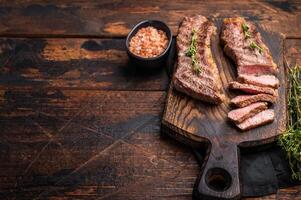 Grilled Tri Tip Steak from Black Angus beef meat. wooden background. top view photo