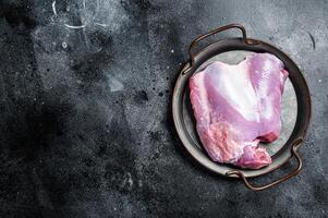 Raw Turkey boneless and skinless thigh fillet. Farm eco meat. Black background. Top view. Space for text photo