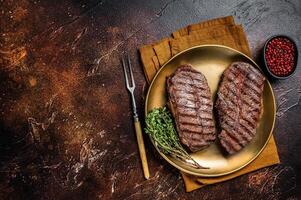 Grilled Shoulder Top Blade or Australia wagyu oyster blade beef steak. Dark background. Top View. Copy space photo