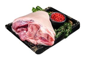 Fresh Raw pork Eisbein knuckle ham in a wooden tray with meat knife. Isolated on white background. Top view. photo