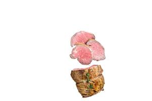 Roast Tenderloin beef fillet meat on a wooden board with herbs. High quality Isolate, white background. photo