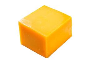 Cheddar Cheese block on a kitchen table. Isolated on white background. photo