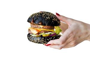 Hands holding a juicy Burger. Isolated on white background. photo