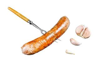 Pork Sausage bbg grilled with spices and herbs on a meat fork. Isolated on white background, Top view. photo