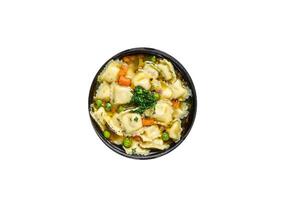 Broth soup with ravioli dumplings pasta in a pan. High quality Isolate, white background. photo