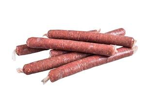 Raw butchers sausages in skins with herbs on kitchen table. Isolated on white background. photo